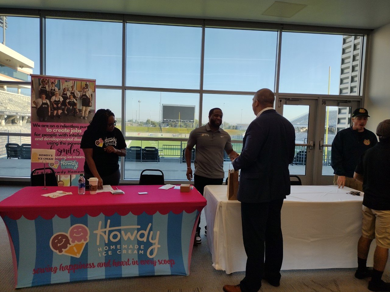 Roderick Batson, center, of Howdy Homemade Ice Cream talks about his company at the Katy ISD Partners in Education Business and Community Partnerships Open House, held Oct. 6 in the conference room at Legacy Stadium.